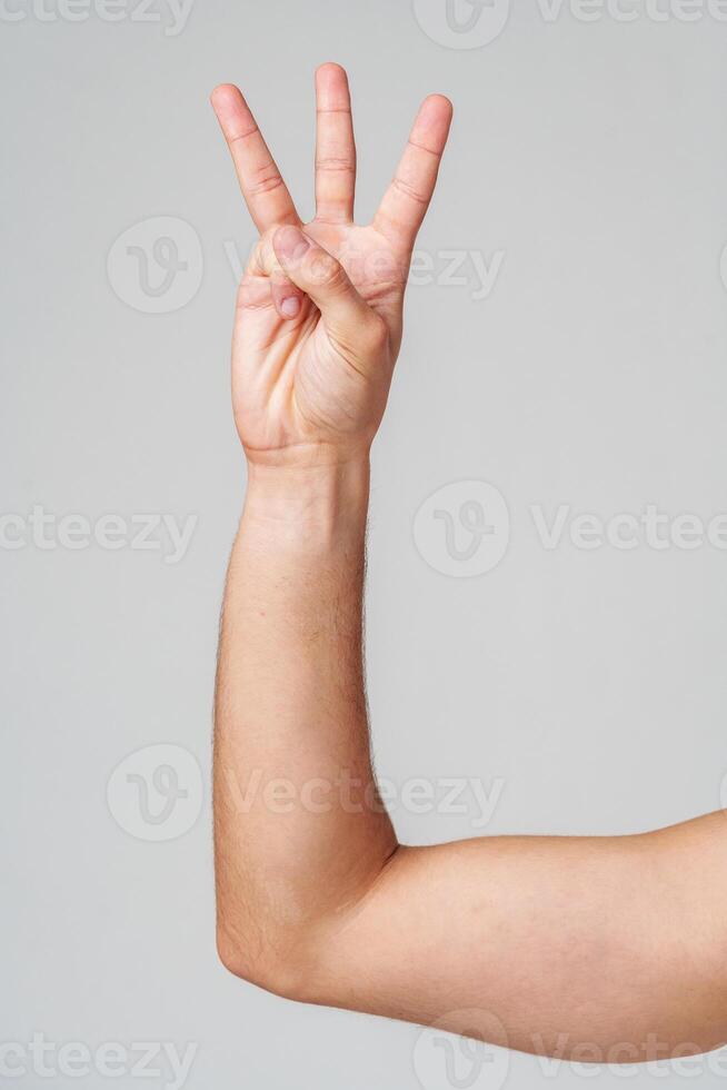 A person hand gesture against a neutral background photo