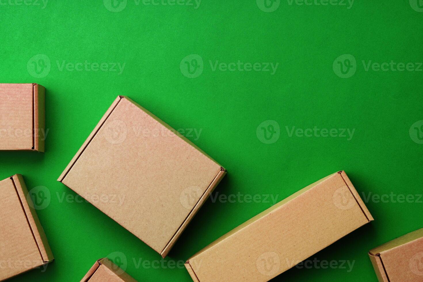 Brown cardboard boxes arranged on a vibrant green surface photo