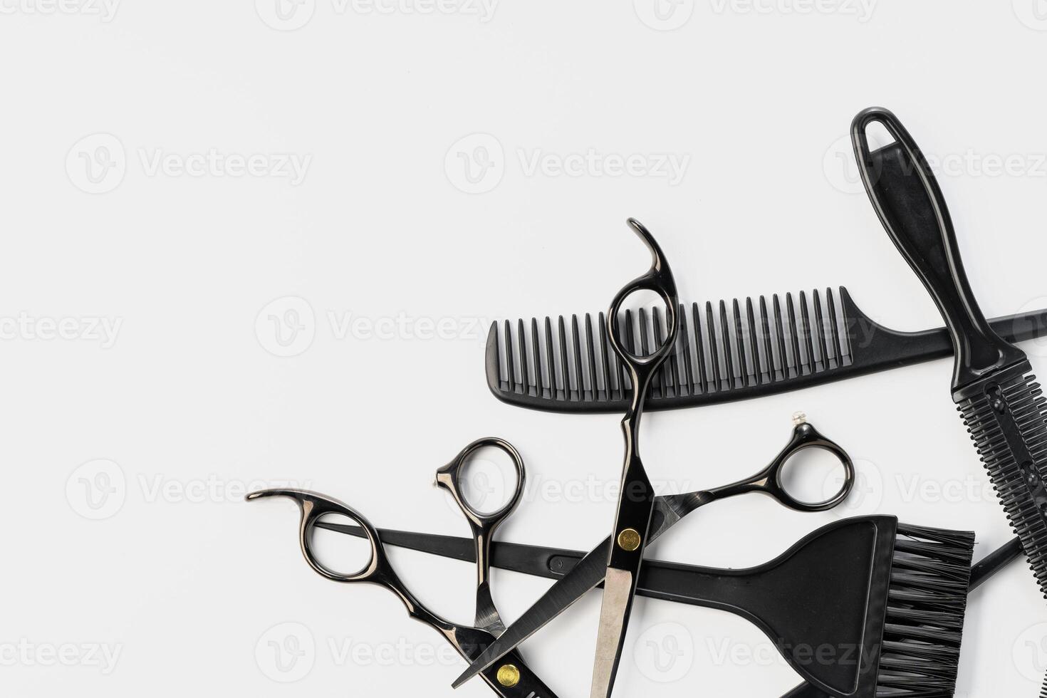 Black hairdressing tools and various hairbrushes on white background photo
