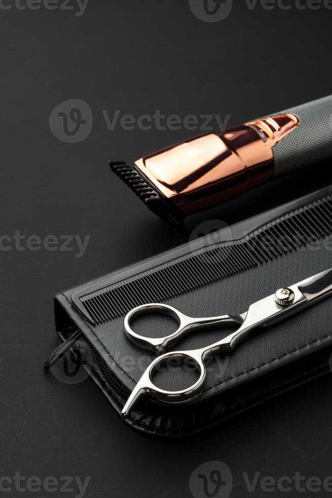 Hairdressing scissors with case on a black background photo