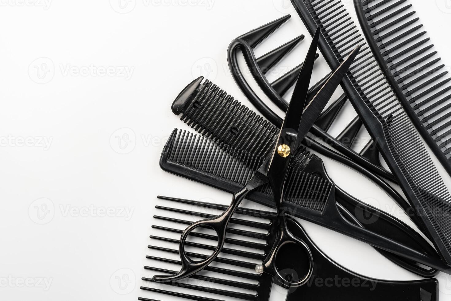Black hairdressing tools and various hairbrushes on white background photo