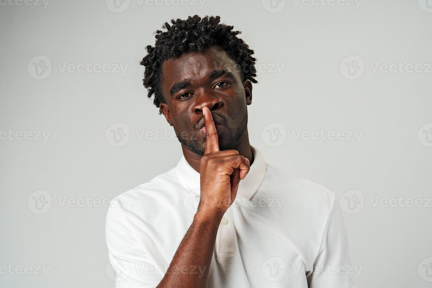 African Man Making a Hush Gesture With Finger photo