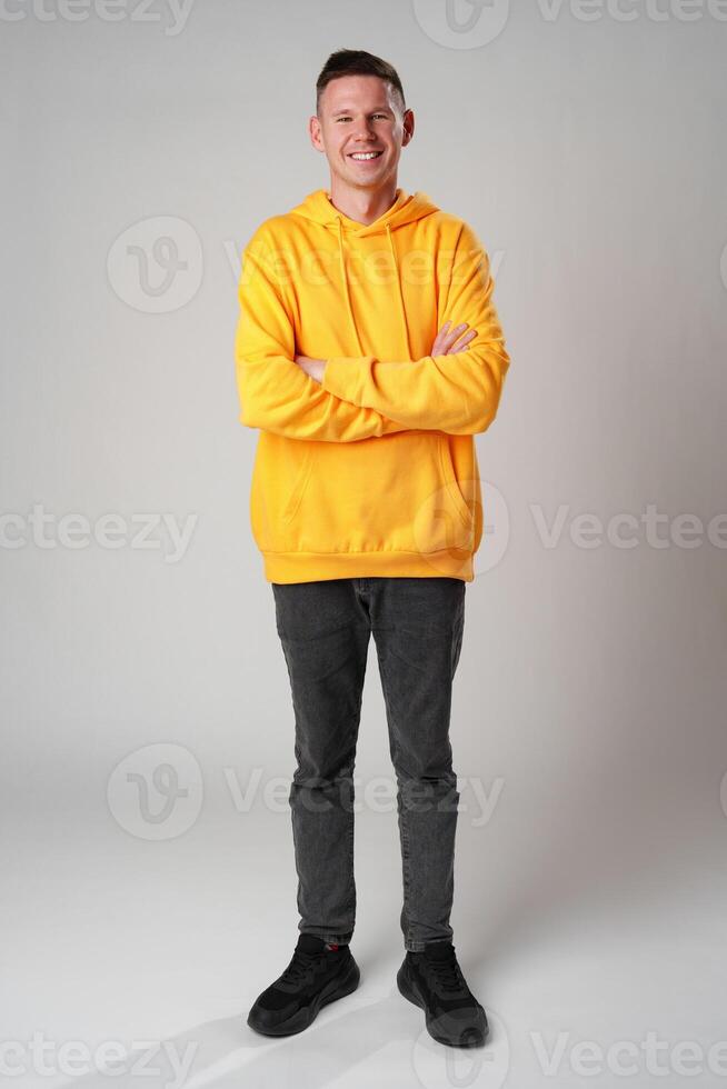 Portrait of a young handsome male in casual clothes on gray background photo