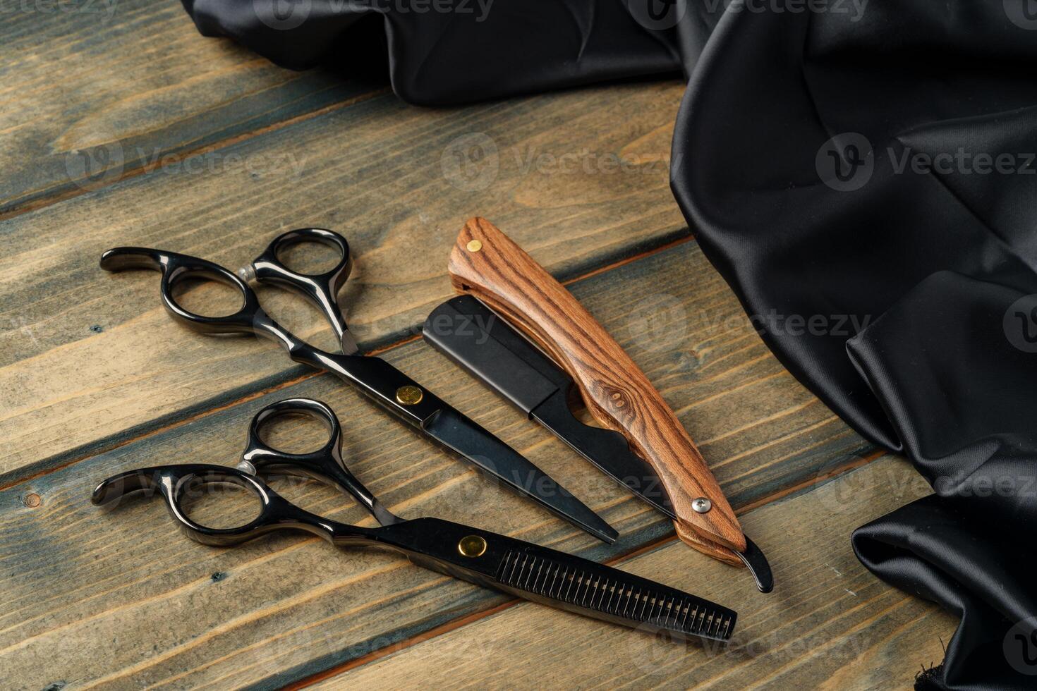 Hairdressing professional scissors on wooden background close up photo