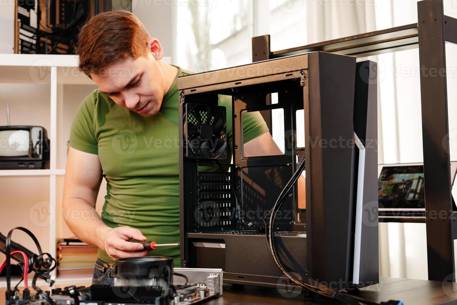 Man assembles a computer system unit at home photo
