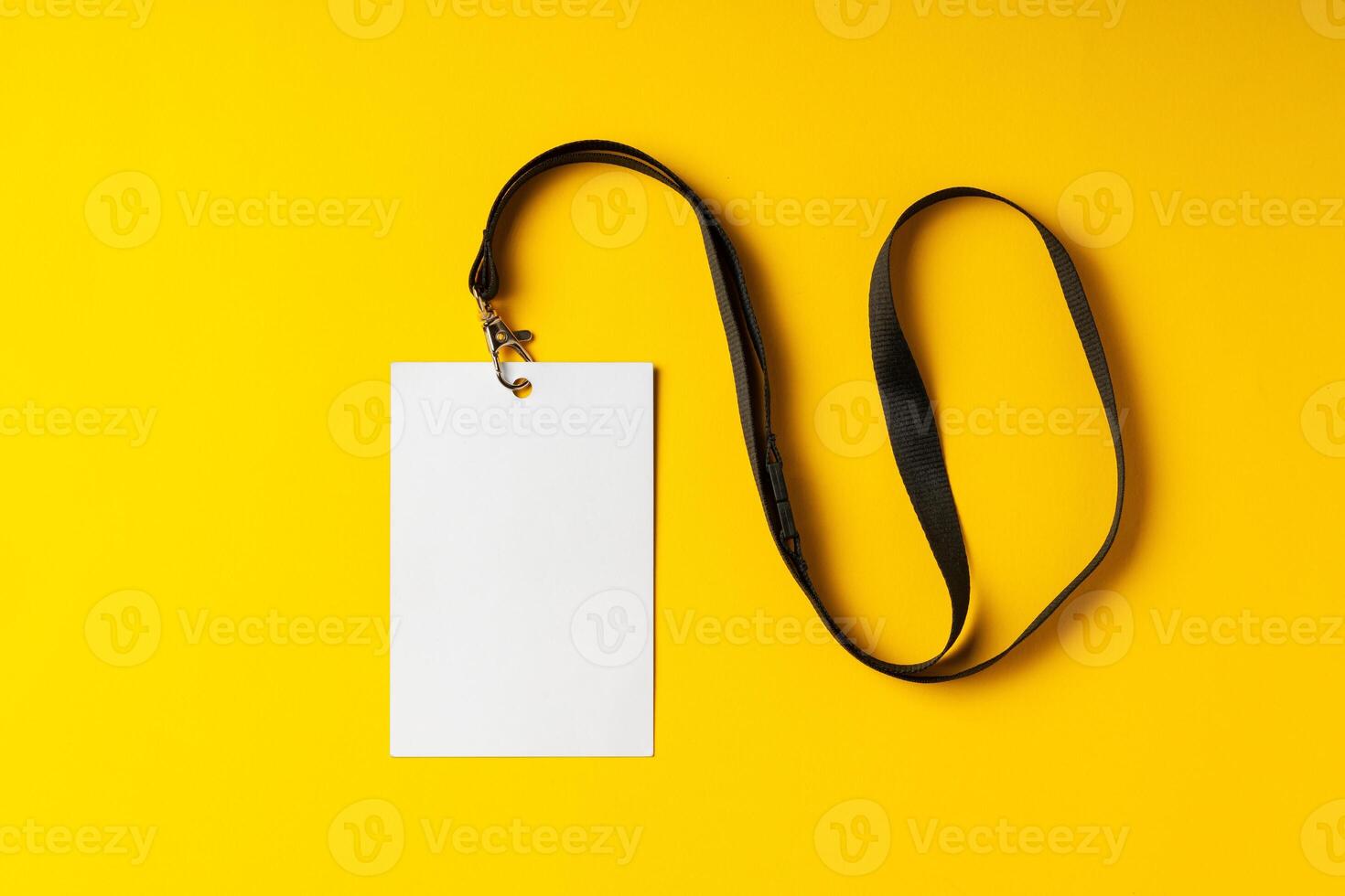 Blank nametag on a string on yellow background copy space photo