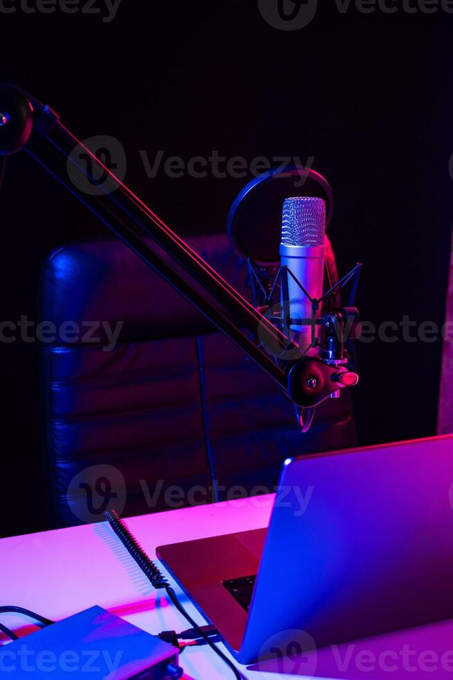 Home studio podcast interior. Microphone, table and chair photo