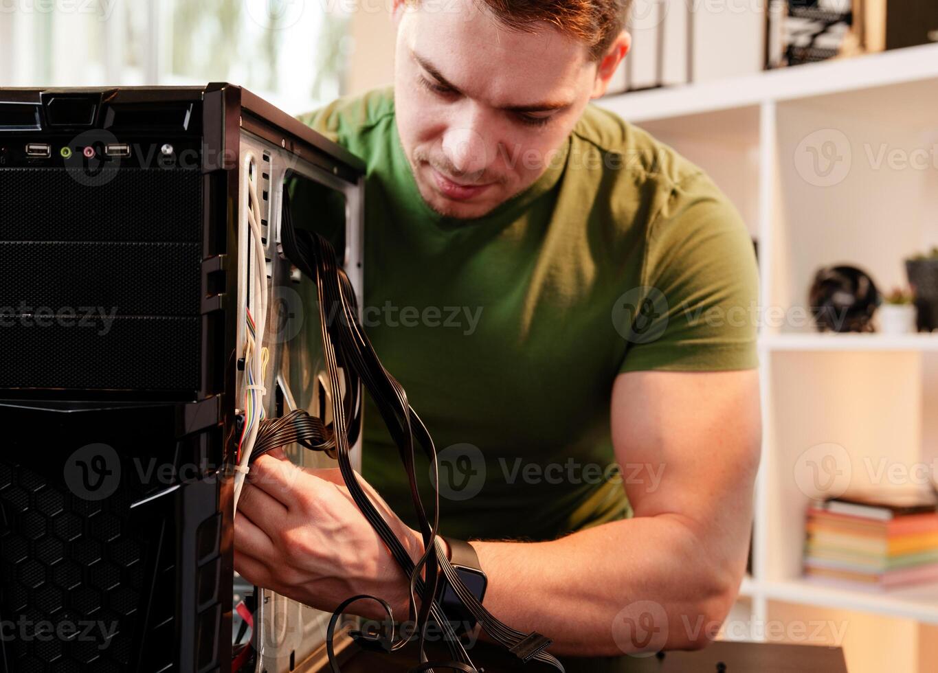 Man assembles a computer system unit at home photo