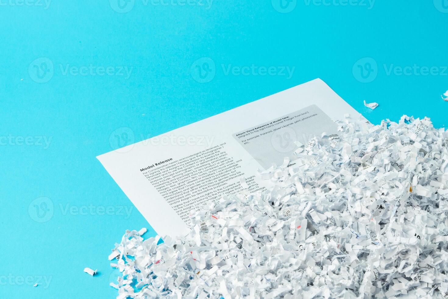 Shredded paper pieces on a blue background photo