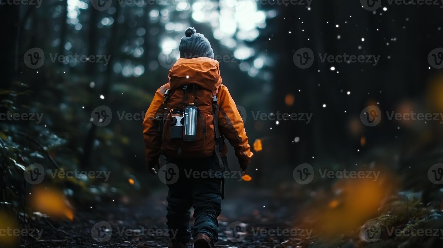 A child walks through a serene forest trail during autumn, enjoying the tranquil atmosphere and falling leaves in the cool air photo