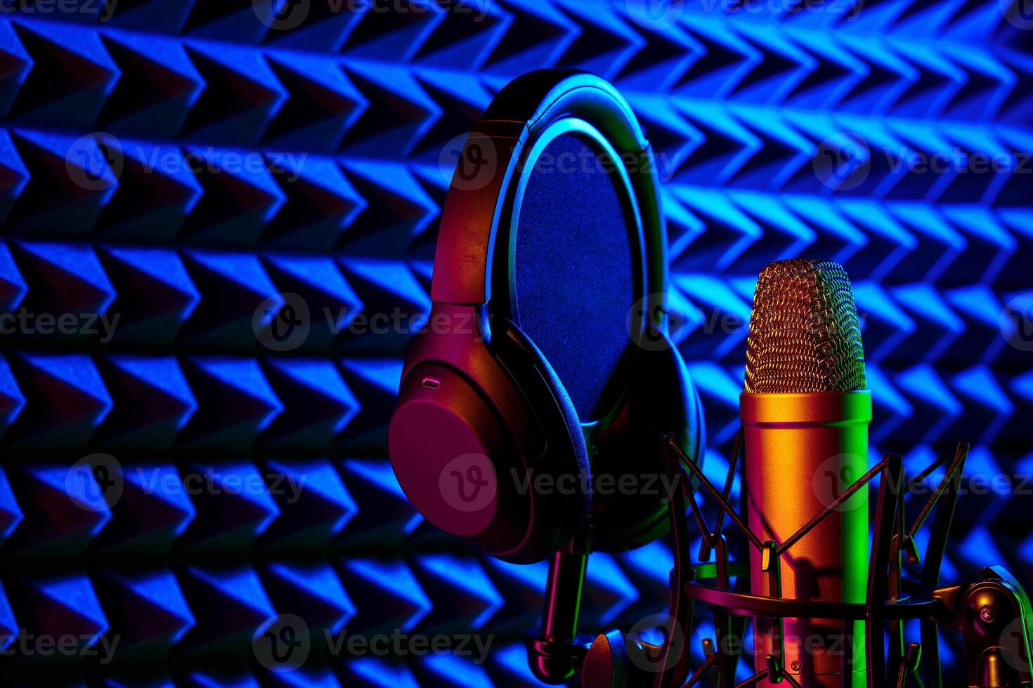 Professional microphone in a recording studio in blue light photo