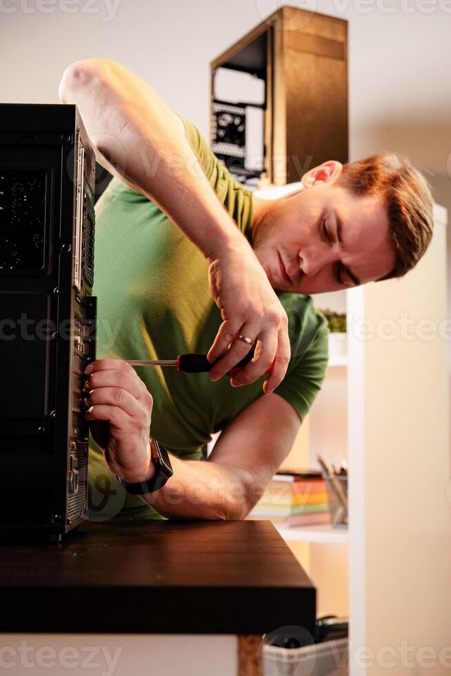 Man assembles a computer system unit at home photo