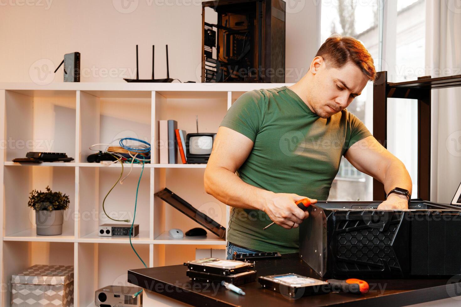 Man assembles a computer system unit at home photo