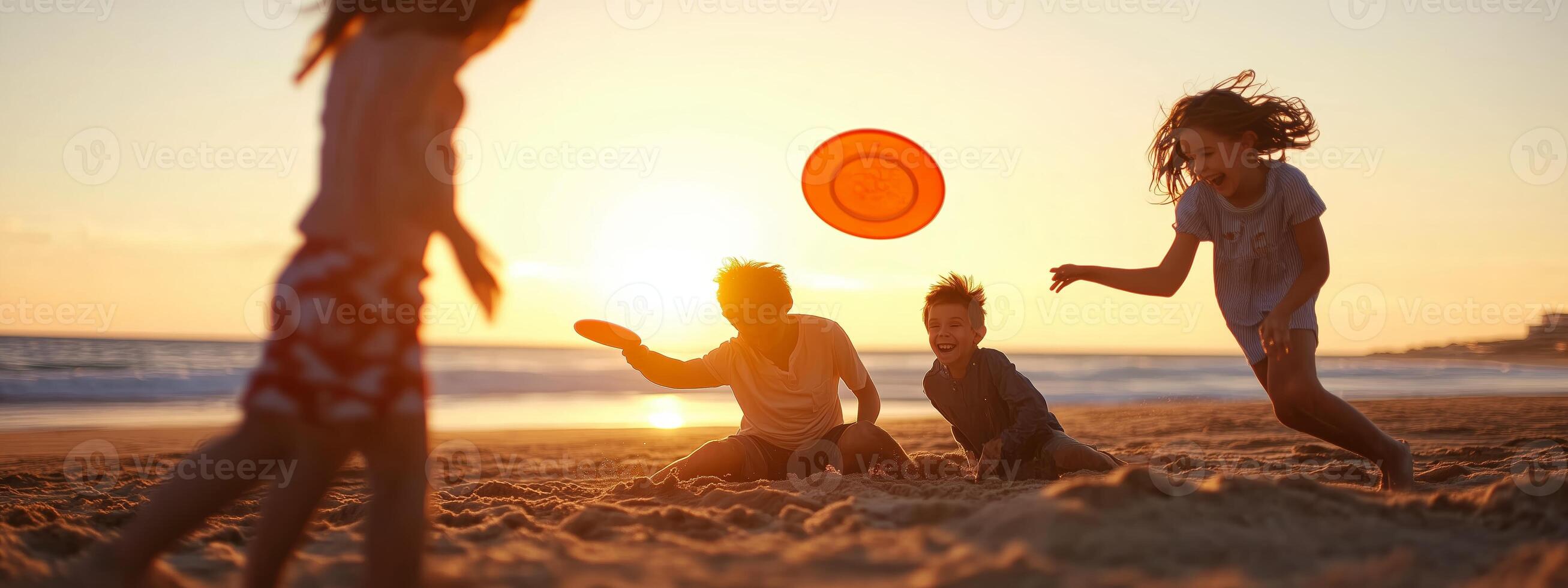 Children playing with a frisbee on the beach at sunset, enjoying a warm evening by the ocean photo