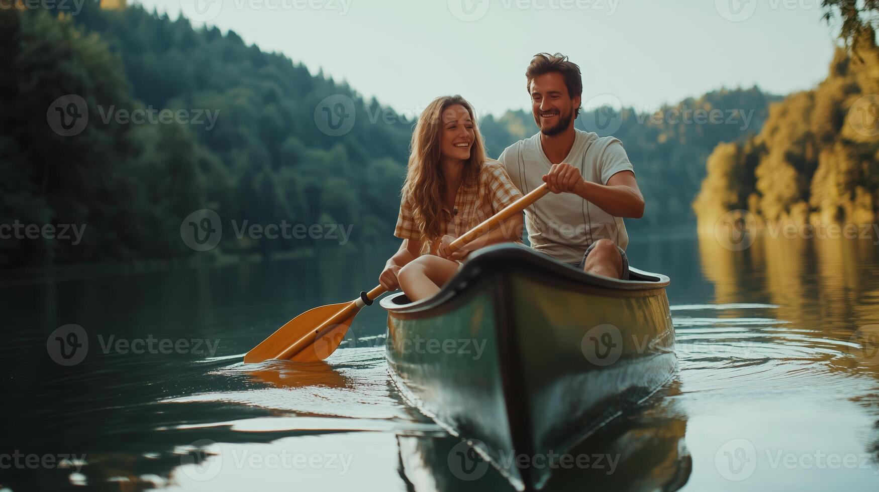 A couple enjoys a leisurely canoe ride on a tranquil lake surrounded by lush green hills during sunset photo