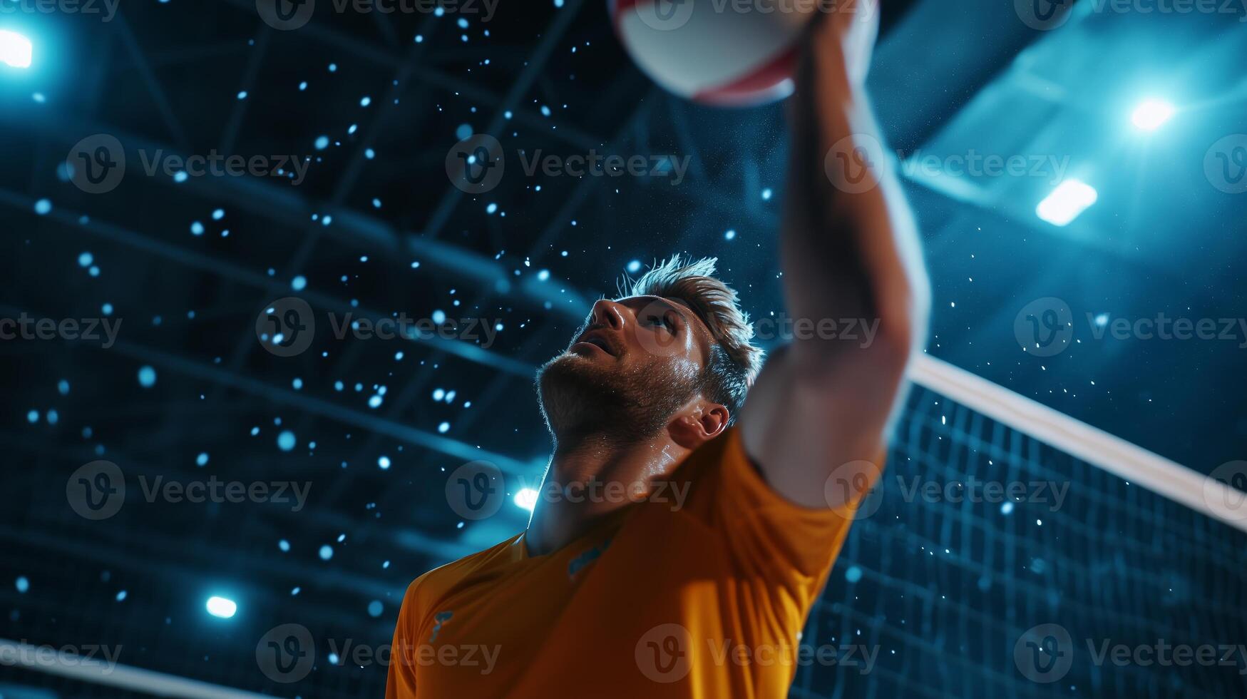 An athlete prepares to serve a volleyball during a thrilling indoor match under dramatic lighting photo