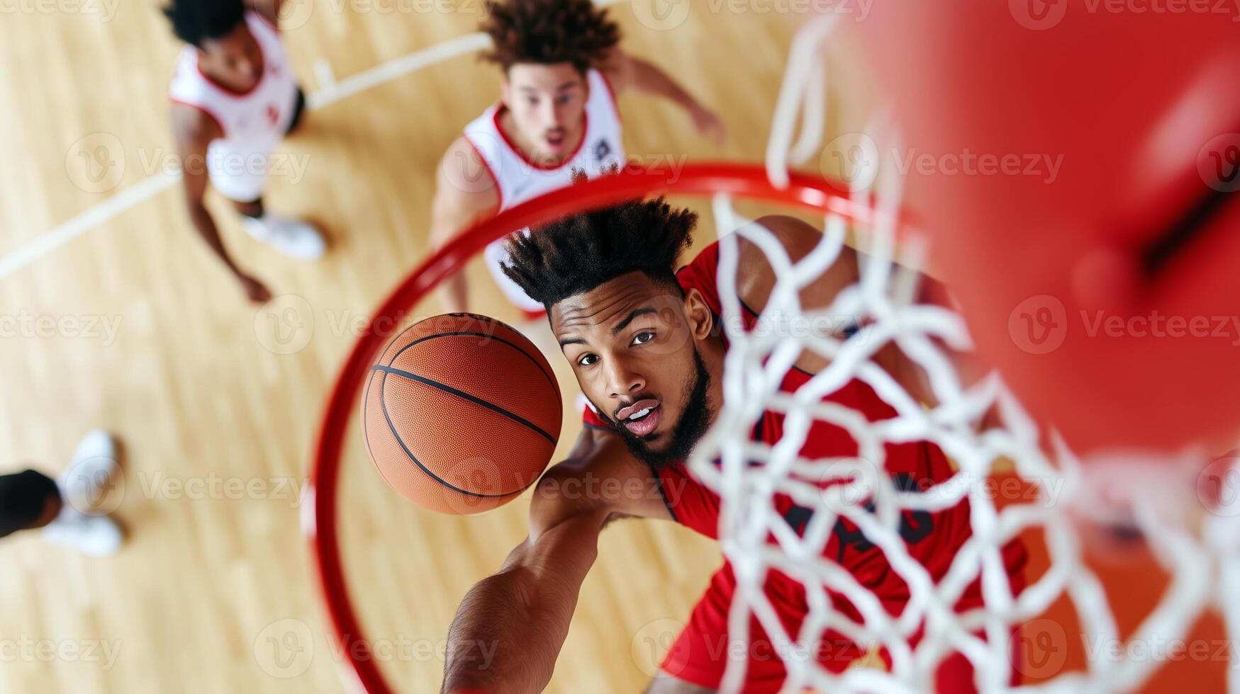 A basketball player attempts a layup while competing with opponents on the court during an intense game photo