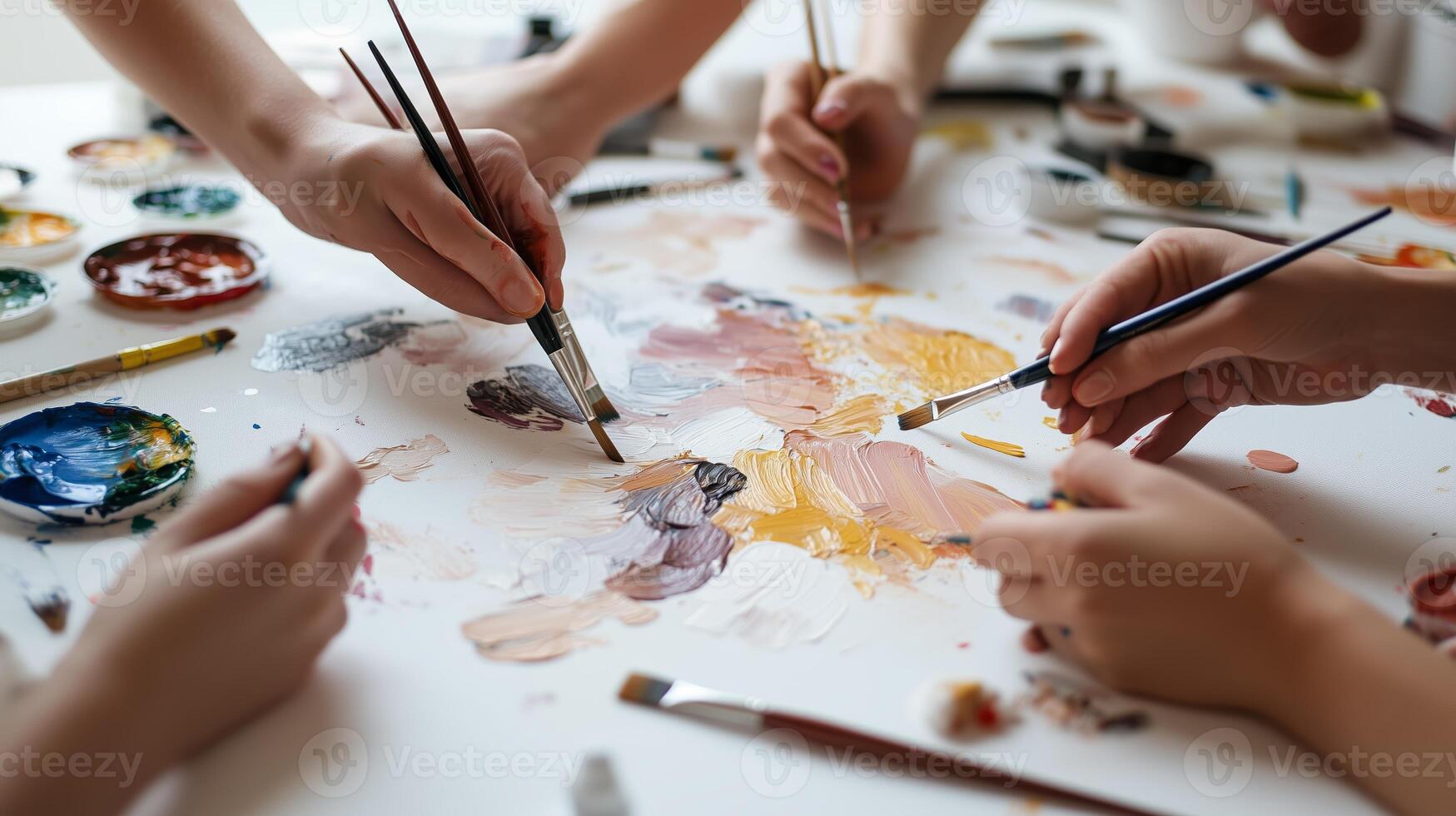 Artistic collaboration in a vibrant studio with hands mixing colors on a palette during a creative group session photo