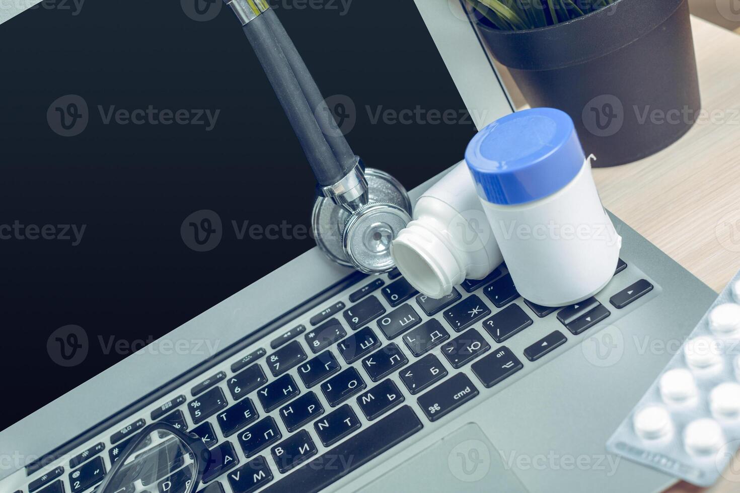 Stethoscope on laptop, close-up photo