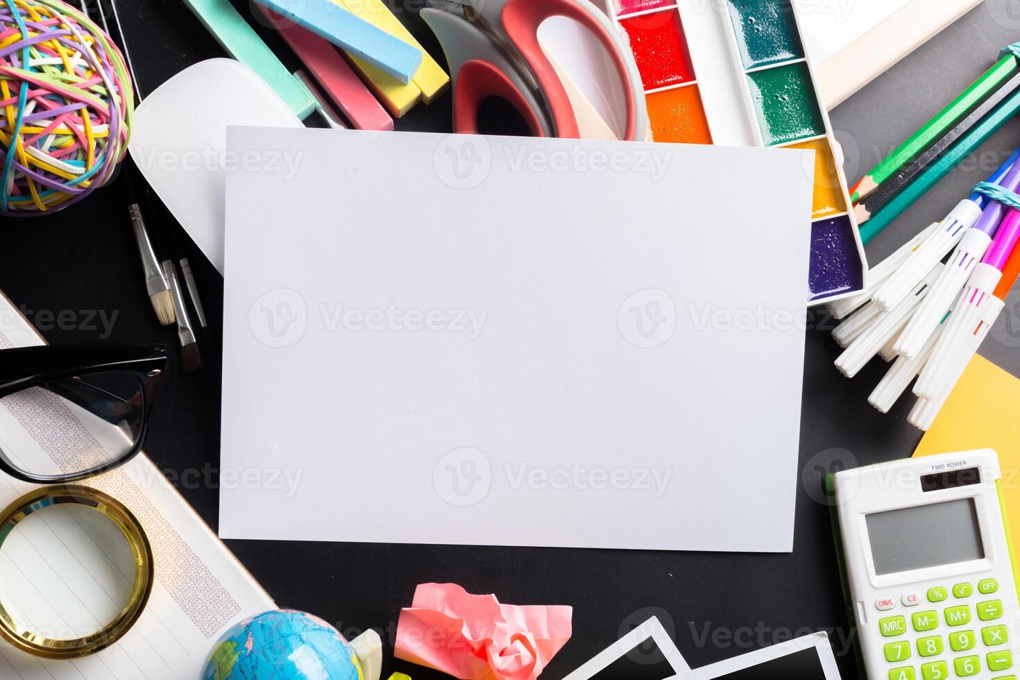 Desk of an artist with lots of stationery objects photo