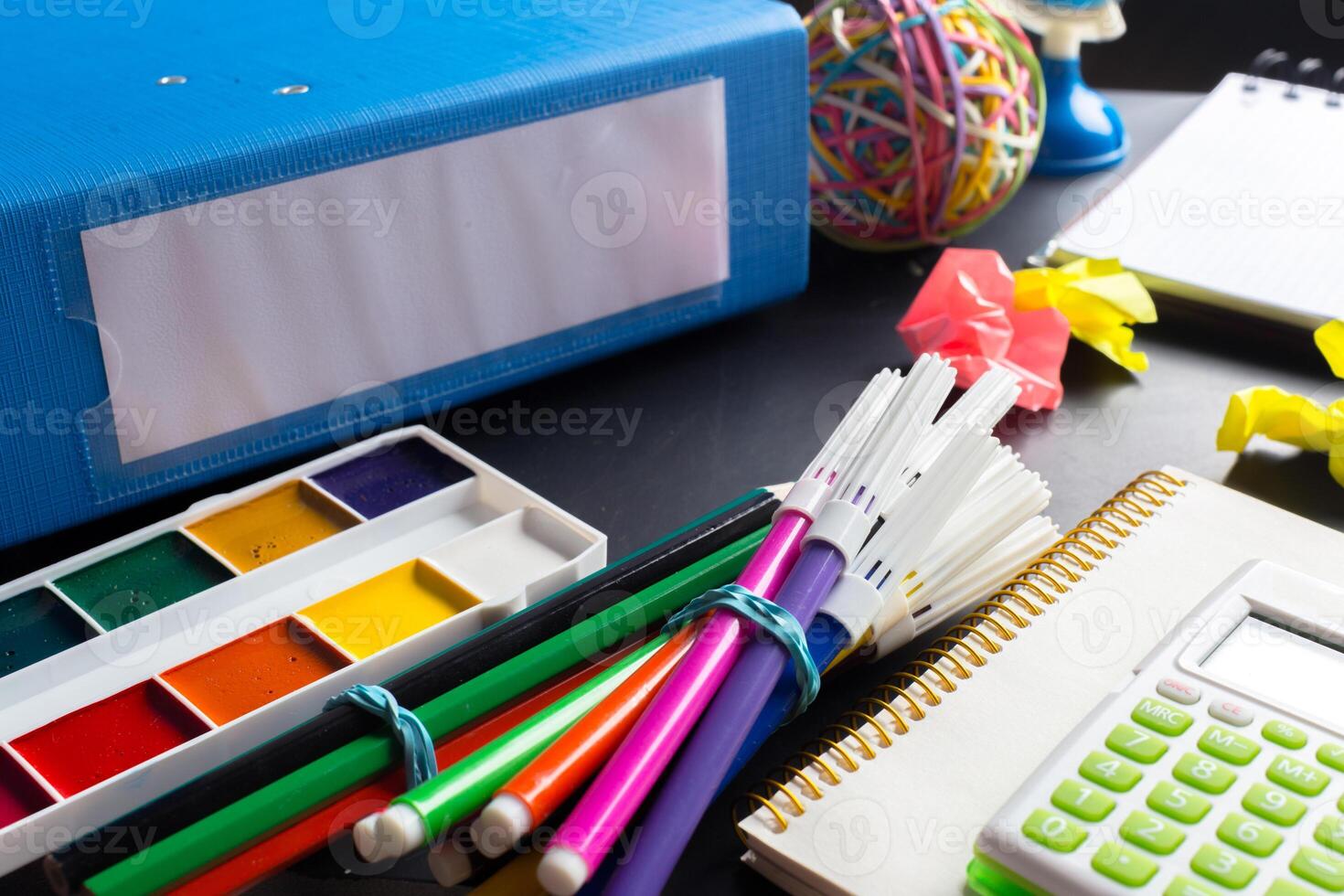 Desk of an artist with lots of stationery objects photo