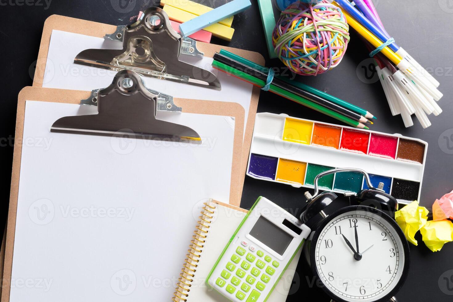 Desk of an artist with lots of stationery objects photo