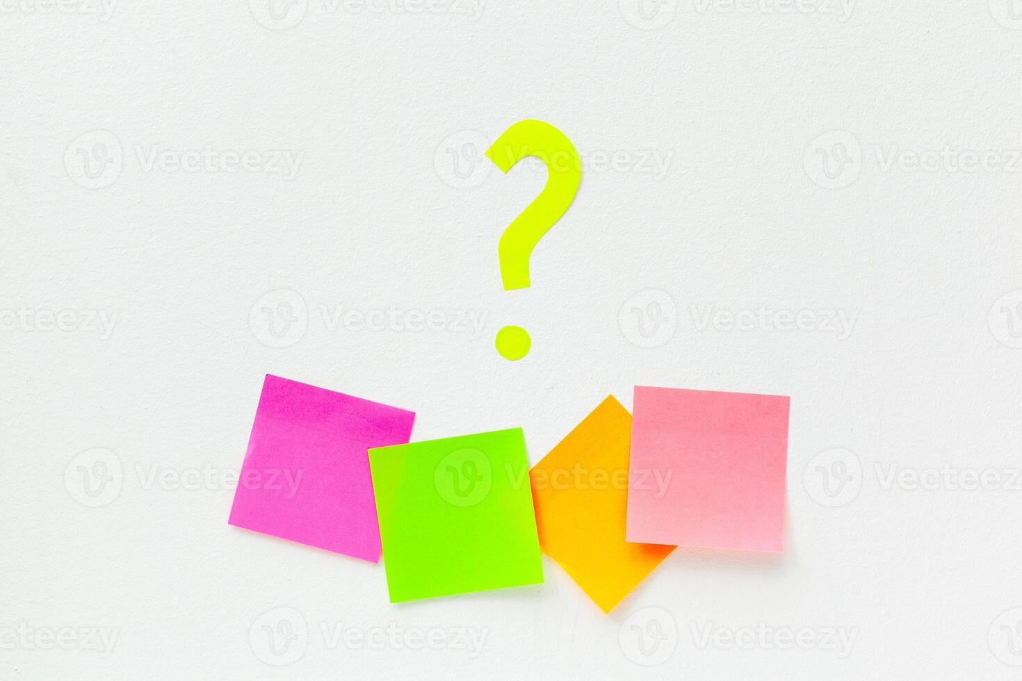 sticky notes with question marks over white photo