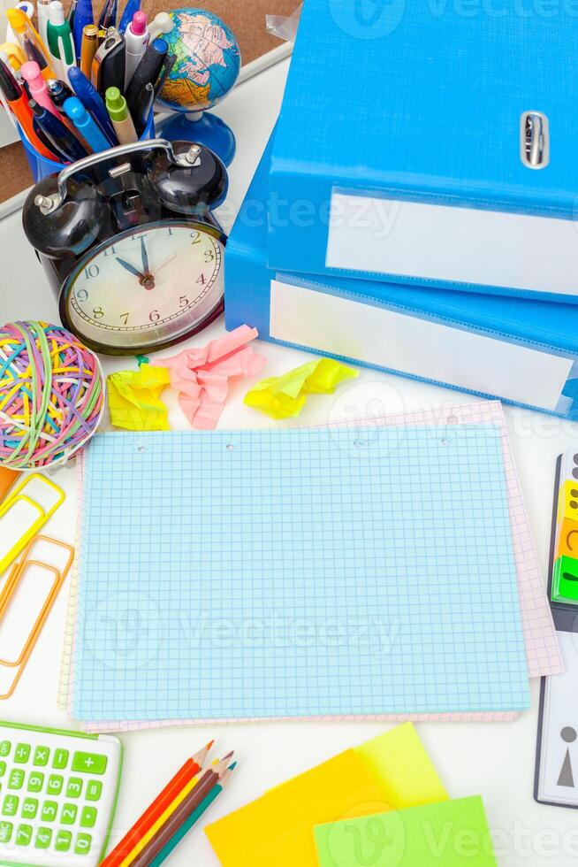 Work place of a creative person with a variety of colorful stationery objects photo