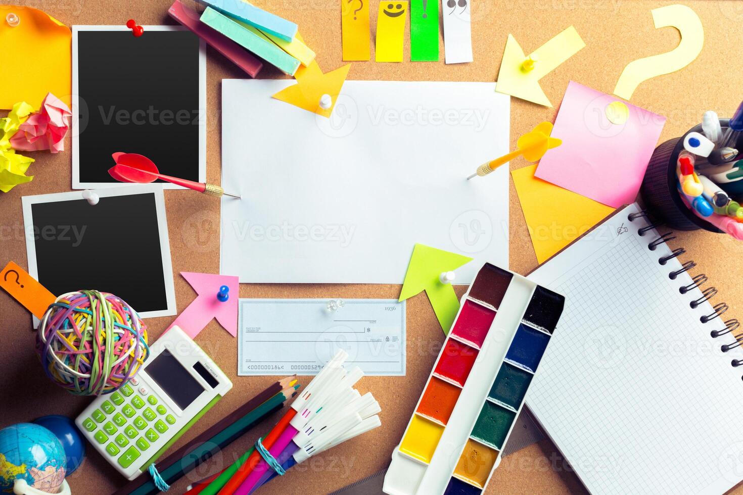 Desk of an artist with lots of stationery objects photo