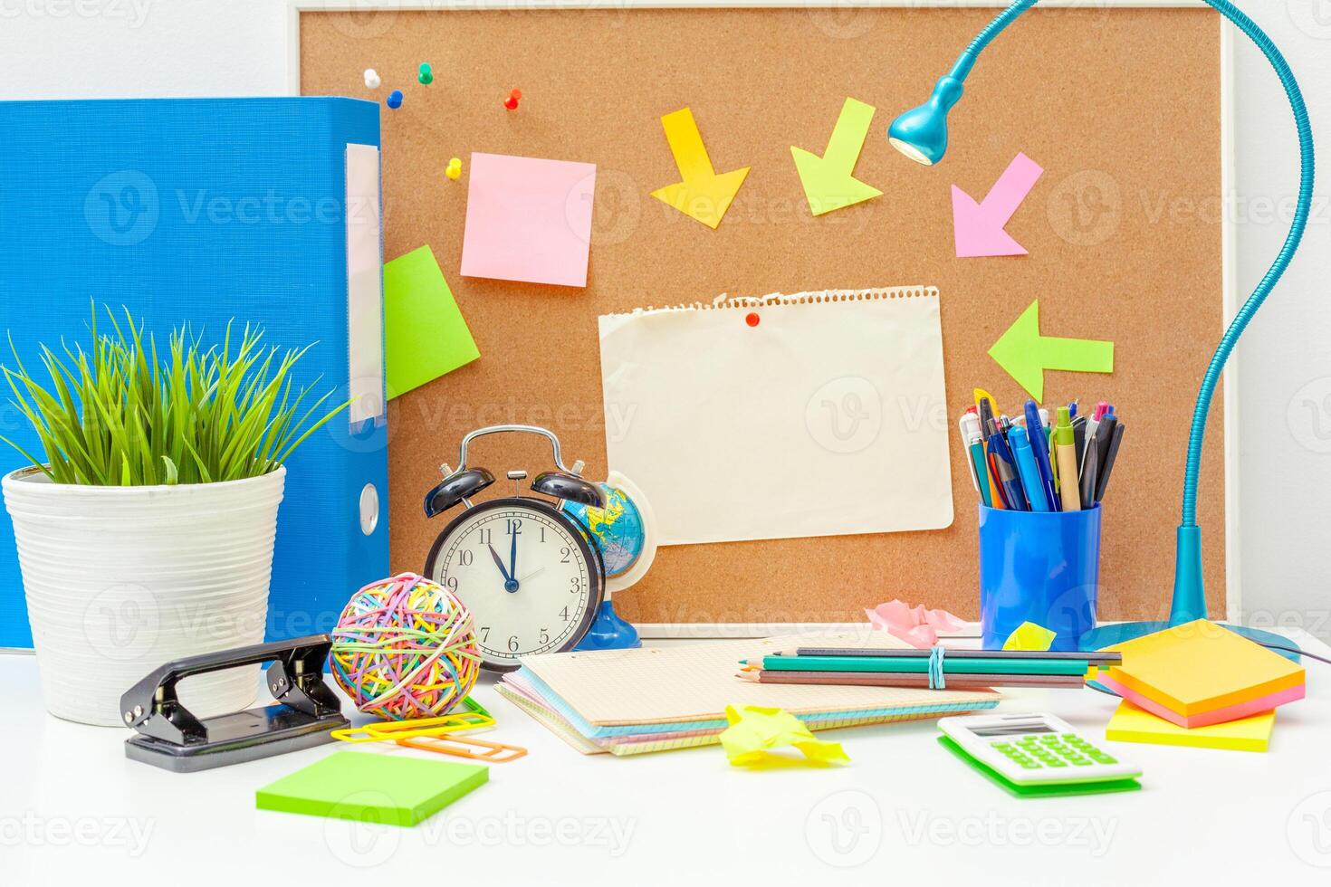 Work place of a creative person with a variety of colorful stationery objects photo