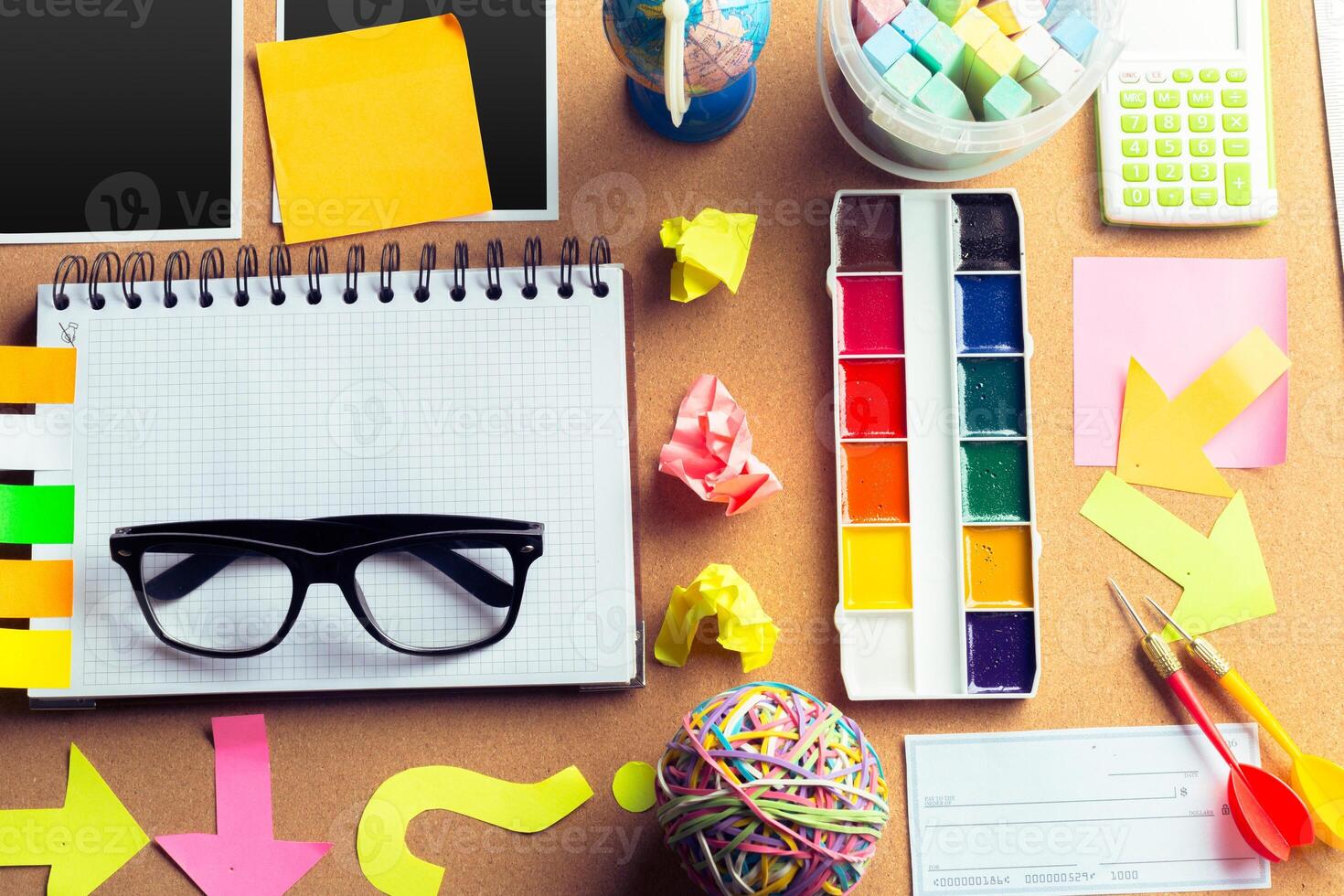 Desk of an artist with lots of stationery objects photo
