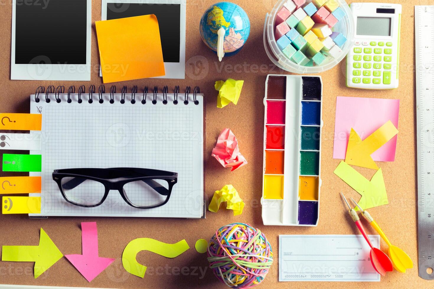Desk of an artist with lots of stationery objects photo