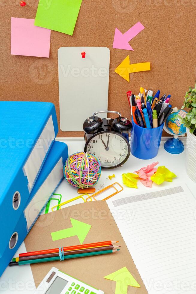 Work place of a creative person with a variety of colorful stationery objects photo