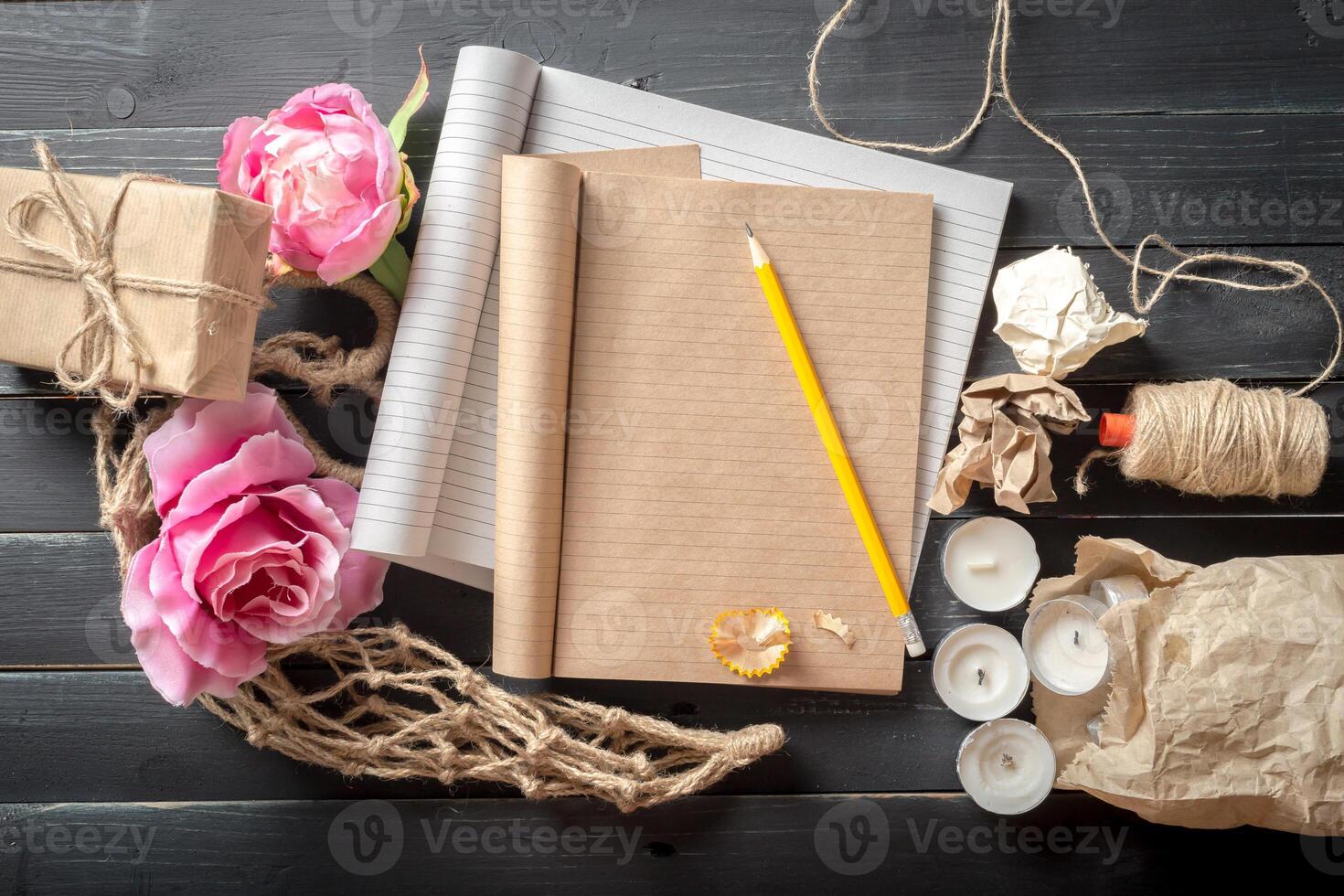 flowers and a notebook on wooden background photo