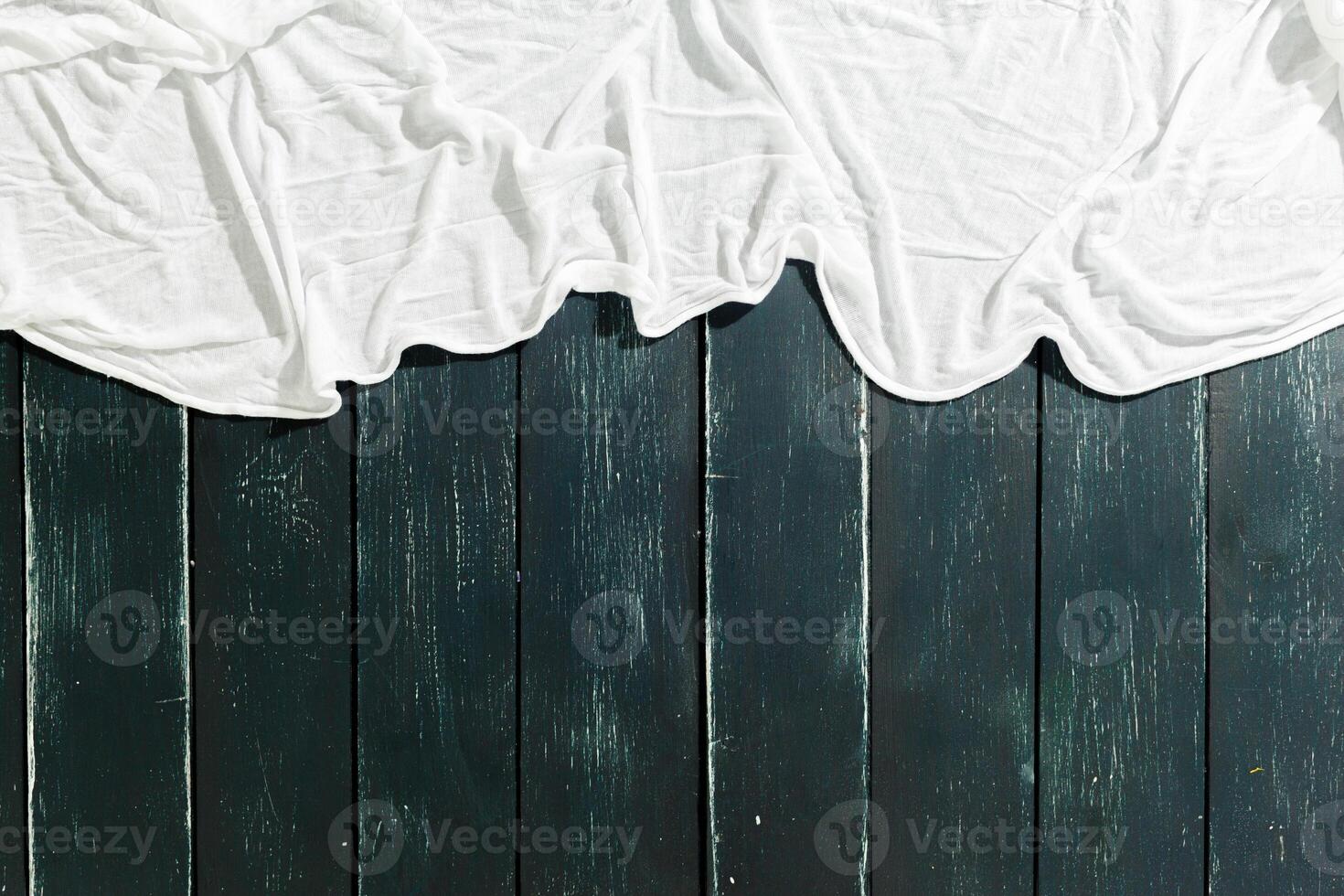 White scarf over black wood table background photo