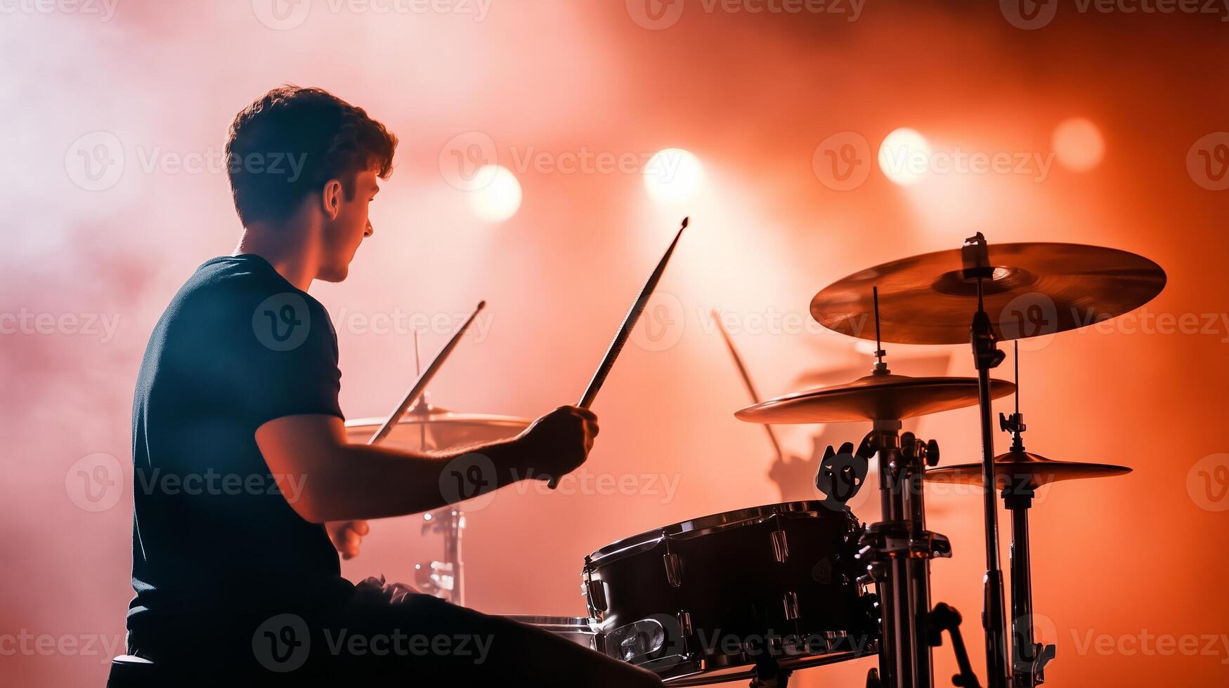 Dynamic drum performance on stage with vibrant lights enhancing the atmosphere during a live concert photo