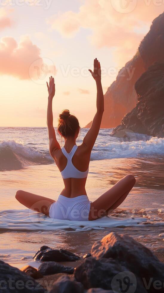 A serene sunset yoga session on the beach, with gentle waves lapping at the shore and cliffs in the background photo