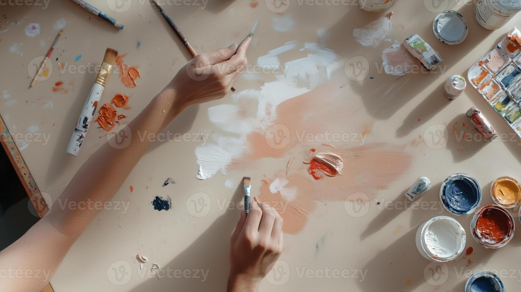 Creative artist's workspace with paint and brushes on a wooden table during a vibrant art session photo