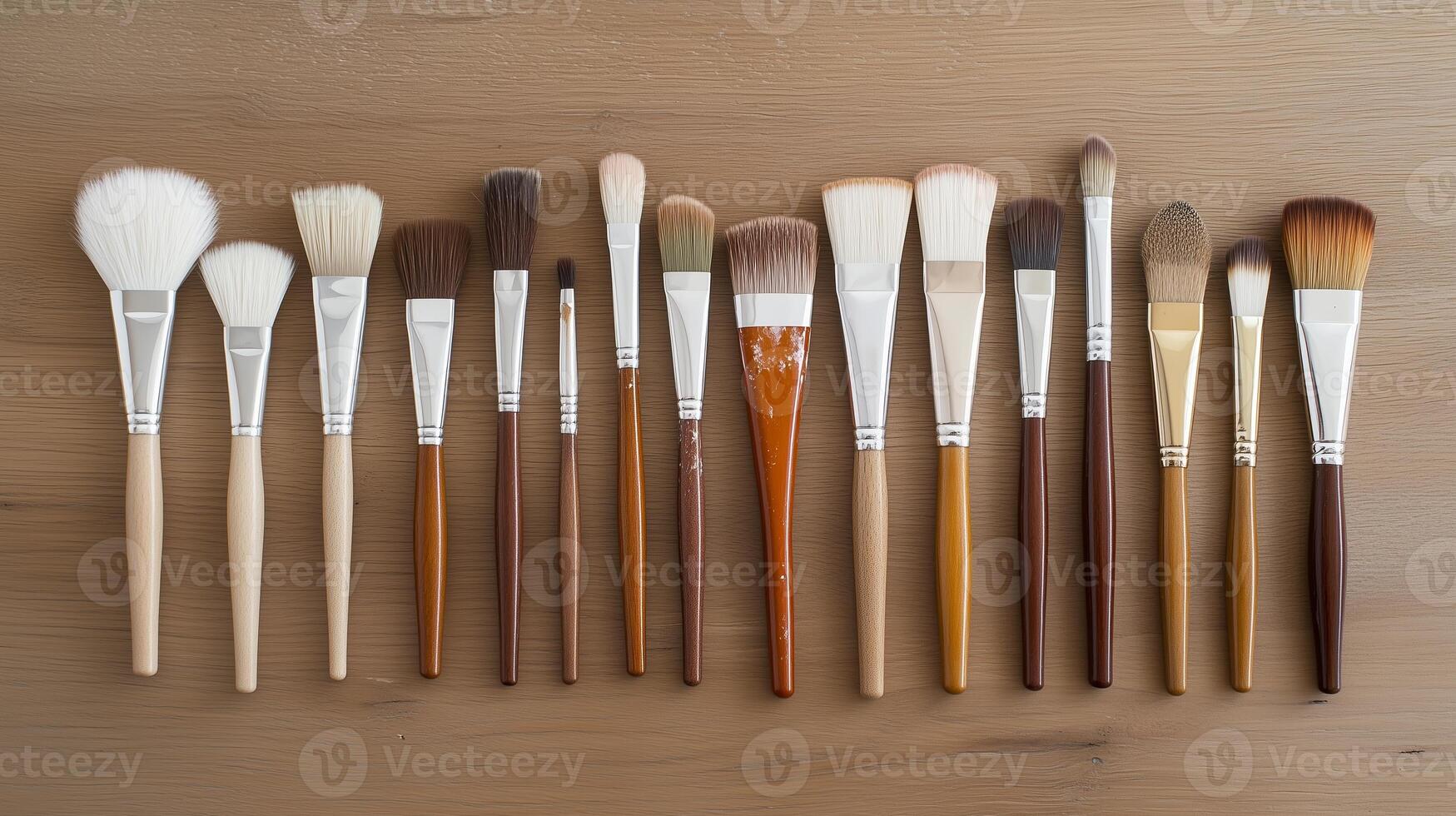 Various makeup brushes arranged neatly on a wooden surface showcasing different sizes, shapes, and bristle types for diverse beauty applications photo