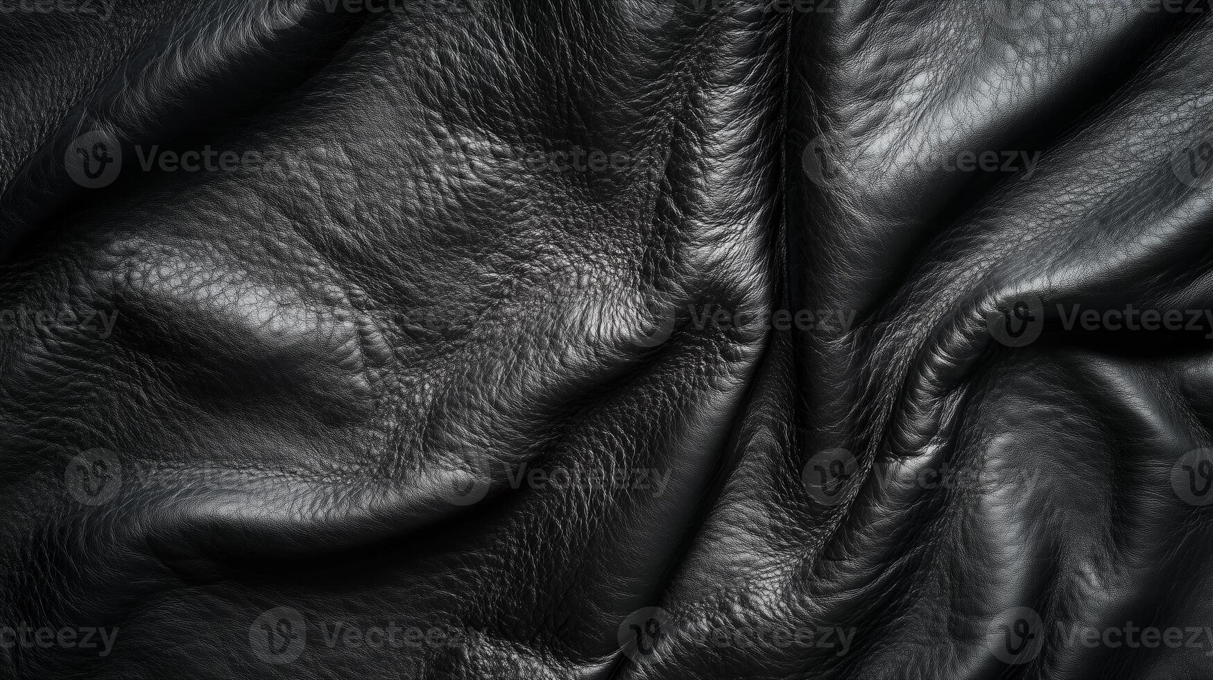 Close-up view of textured black leather fabric showcasing its natural wrinkles and soft sheen, perfect for upholstery or fashion in a studio setting photo
