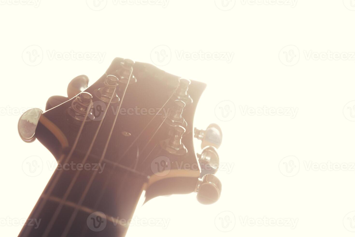Electric guitar body and neck detail on wooden background photo