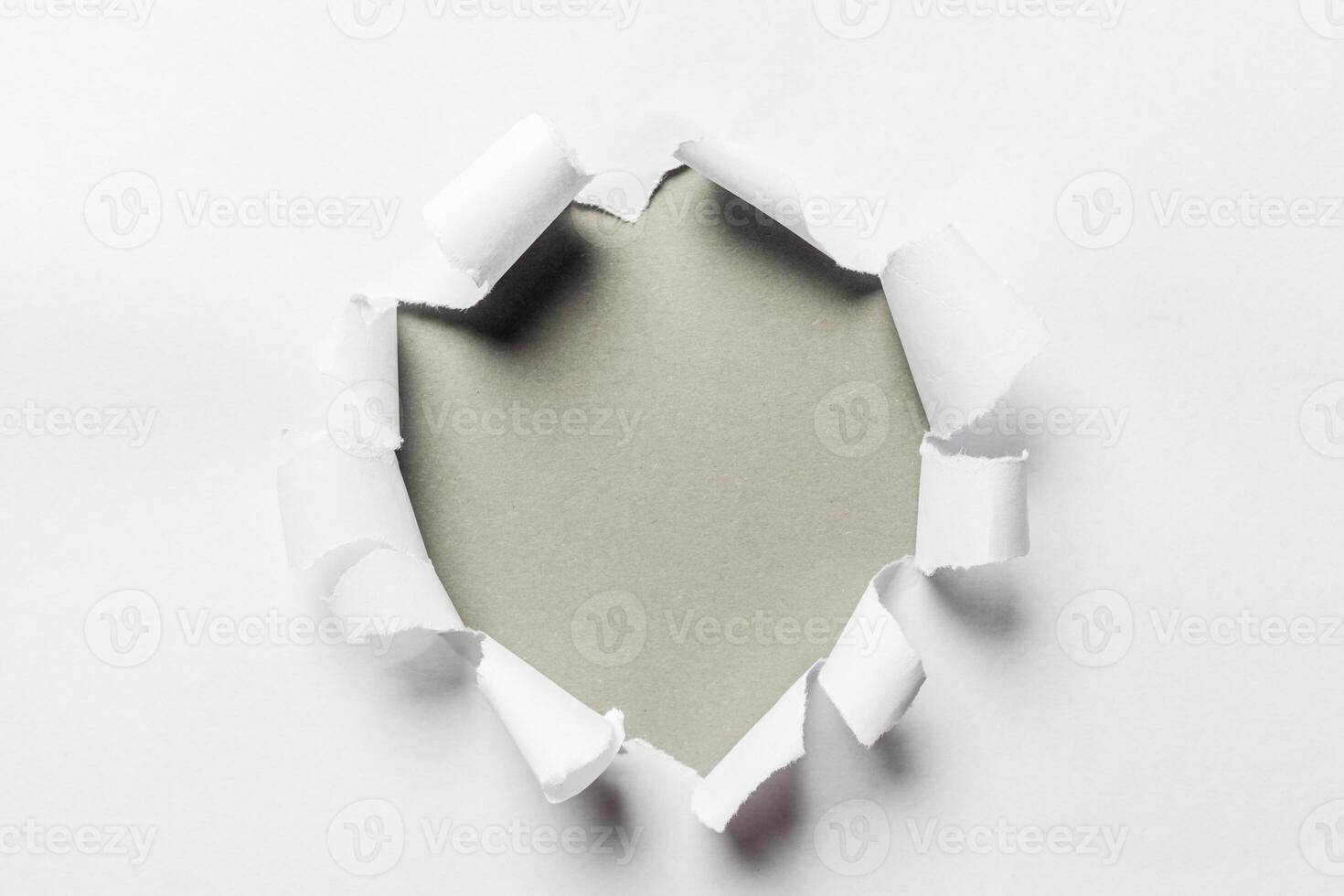 Hole in the paper with torn sides photo