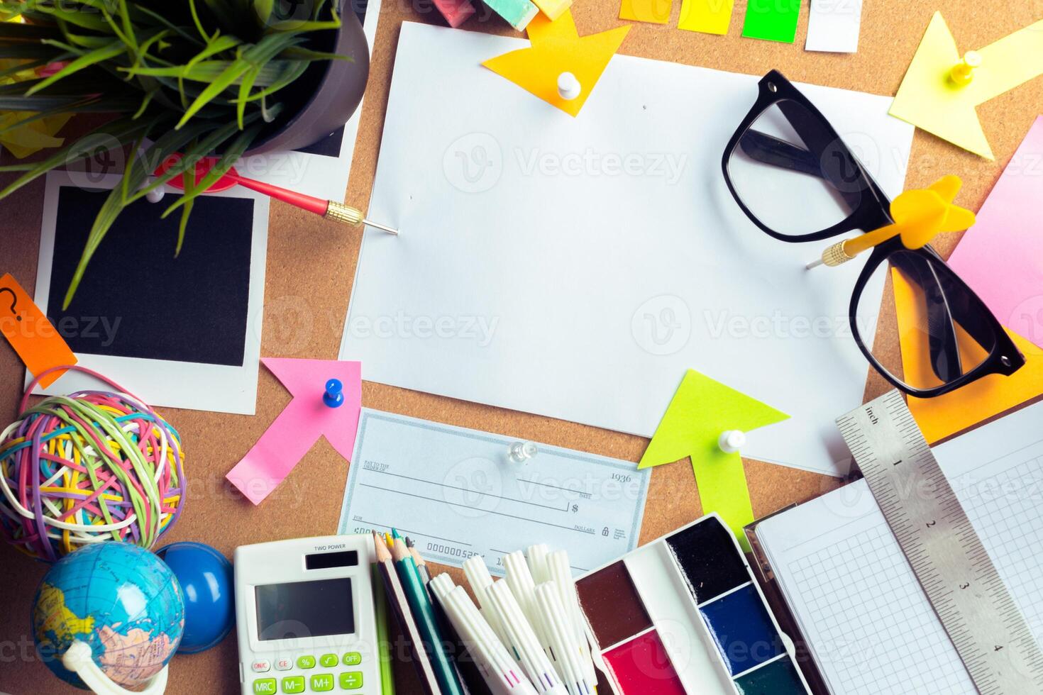 Desk of an artist with lots of stationery objects photo