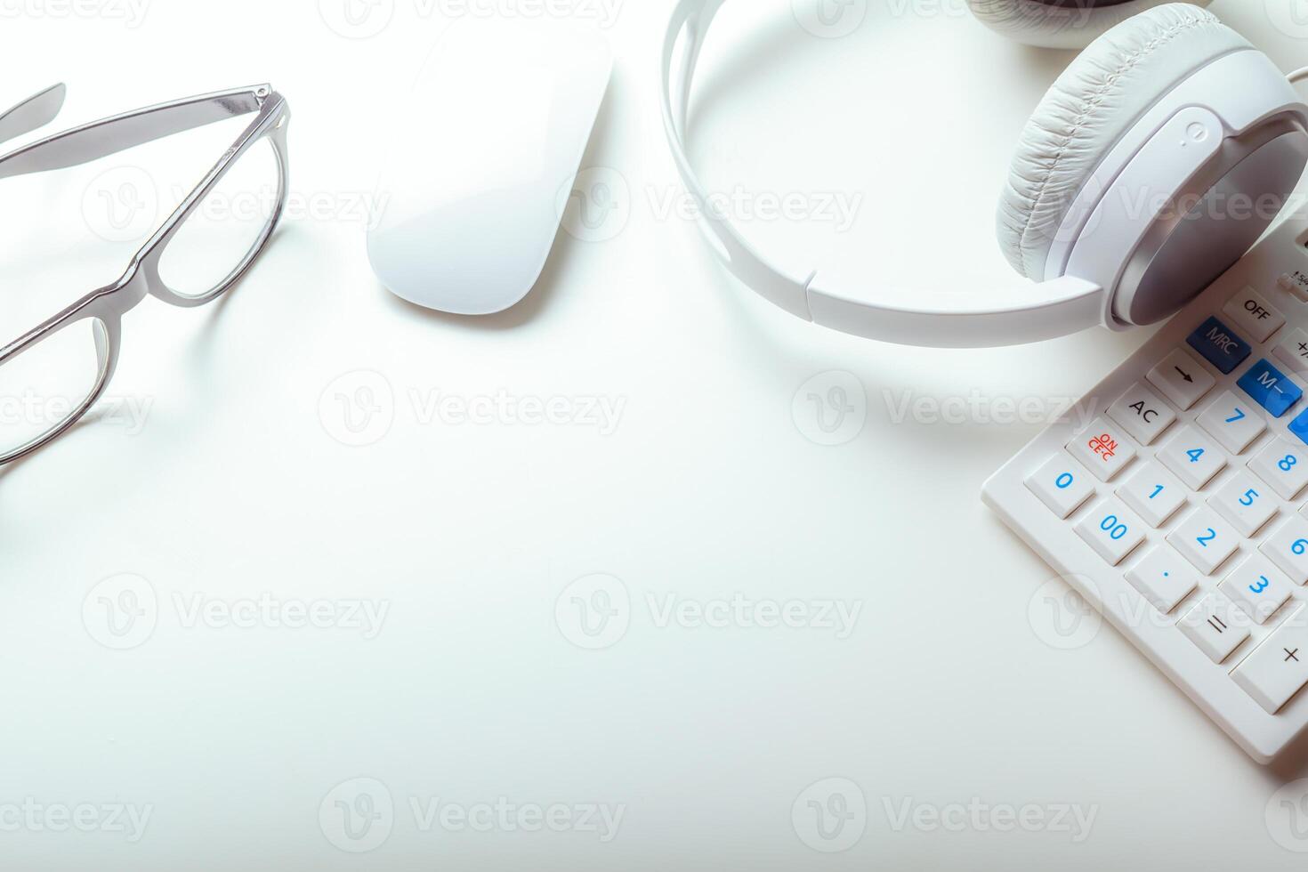 Office desk table with computer keyboard, supplies, calculator, pen, glasses photo