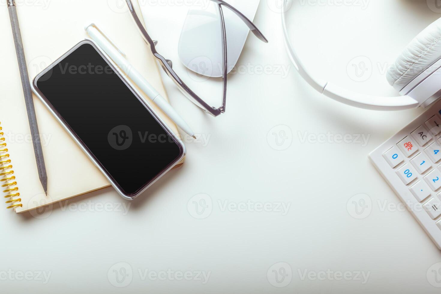 Office desk table with computer keyboard, supplies, calculator, pen, glasses photo
