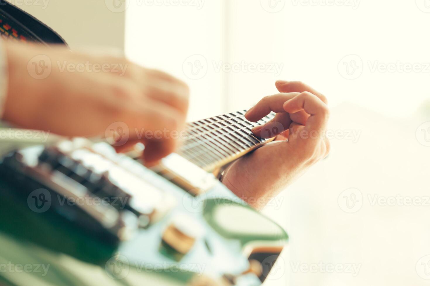 man playing electric guitar photo