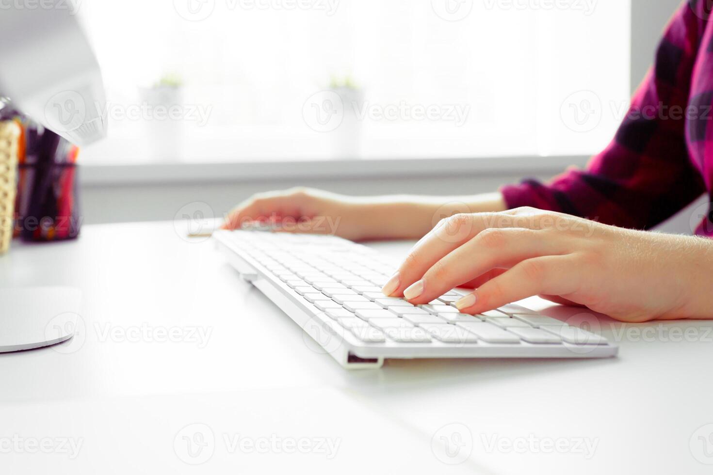 Hands of an office woman typing photo