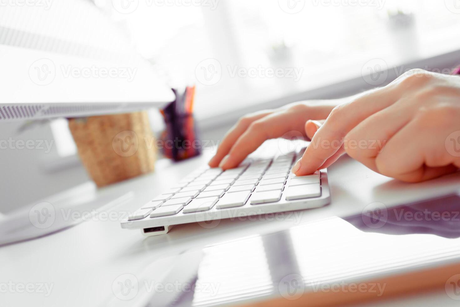 Hands of an office woman typing photo