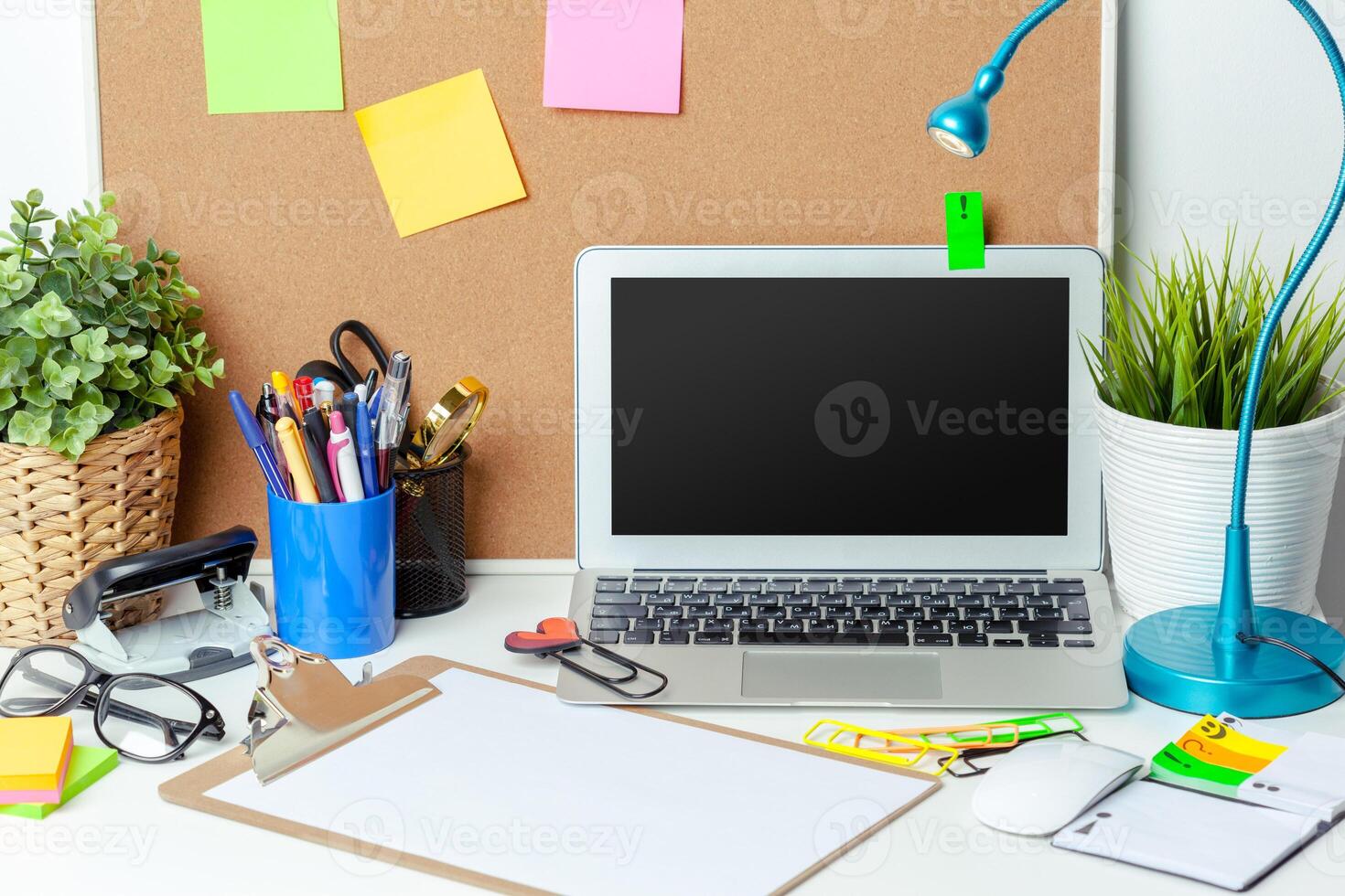 Work place of a creative person with a variety of colorful stationery objects photo