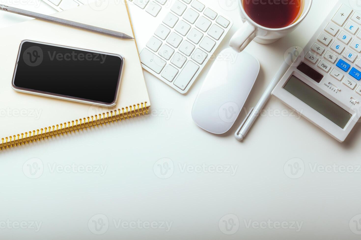 Office desk table with computer keyboard, supplies, calculator, pen, glasses photo